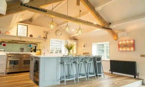 Spacious kitchen with a large island, star-shaped pendant lights, and cozy decor.