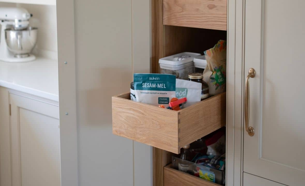 A kitchen drawer pulled out, revealing stored food items and containers.