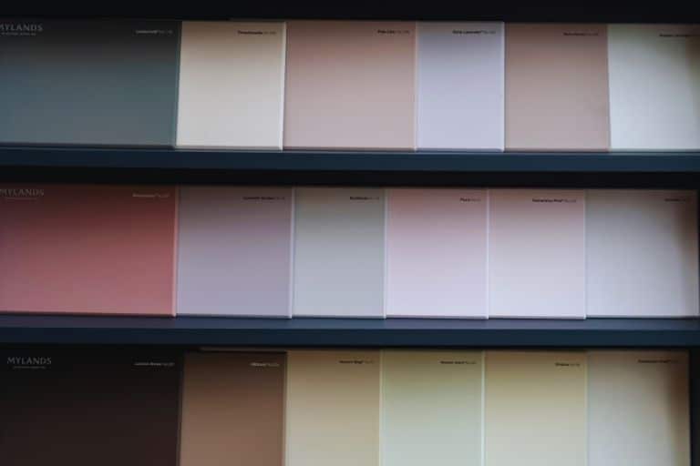 Colorful samples displayed on a blue shelf.