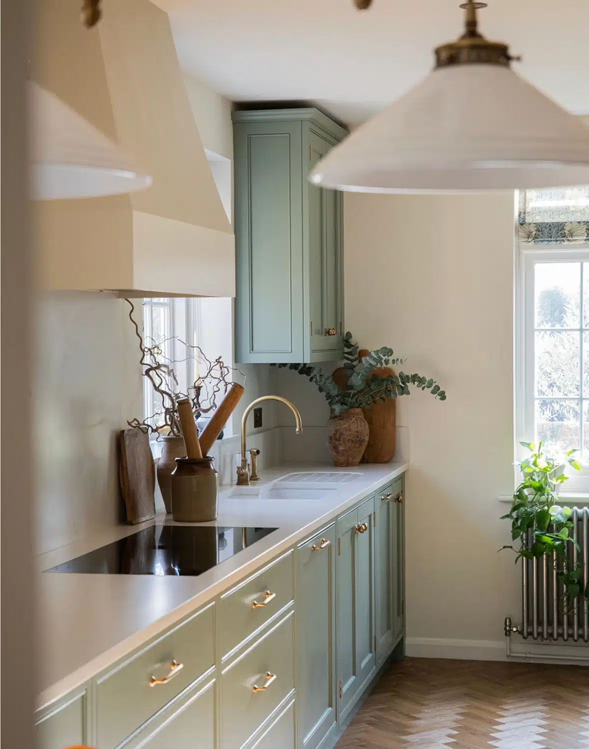 4 Bright kitchen with an island, wicker chairs, wood floor, and large windows letting in natural light.